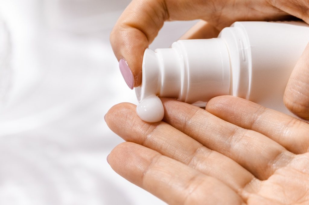 Moisturising cream being squeezed onto a hand.